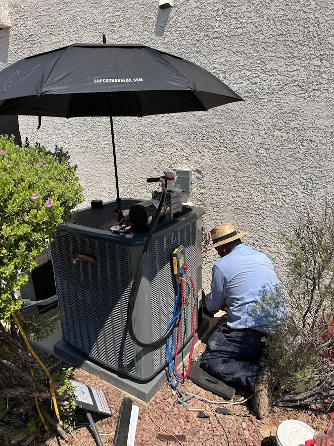 HVAC technician performing outdoor AC maintenance in Castle Pines